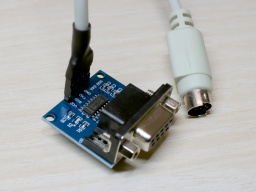 A TTL-to-DB9 converter board and a PS/2 cable connected to it