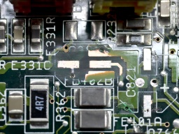 The connection between the left pad and the via was broken, presumably while scraping off the solder mask.