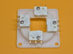The four directional switches are mounted to the frame using the four shorter original screws. Check the correct position of the plungers, and make sure the switches are lying flush to the frame.