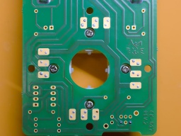 The bottom side, with the four screw heads centered in their PCB holes.