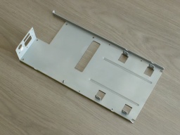 The PSU/floppy frame, coated with fresh zinc.